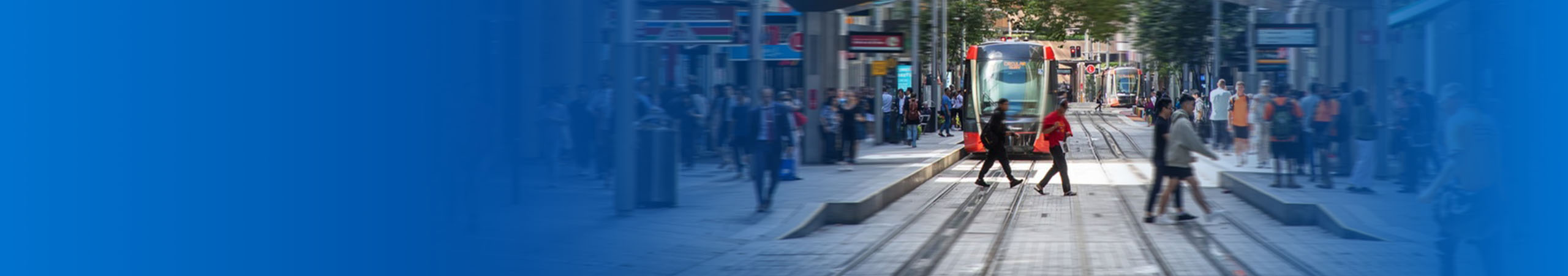 Pedestrians walking across the tram track in Sydney CBD